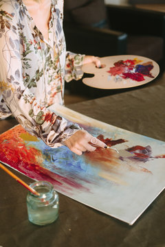 Artist painting at his home