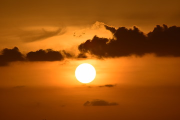 Sunset in the mountains,  Sun is seeing like a ball which is dropping from hand. Click from my home.