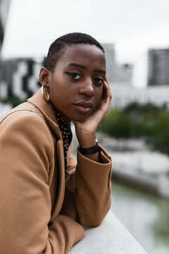 Dreamy black lady looking at camera on street