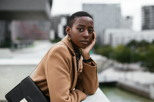 Elegant black female standing on terrace