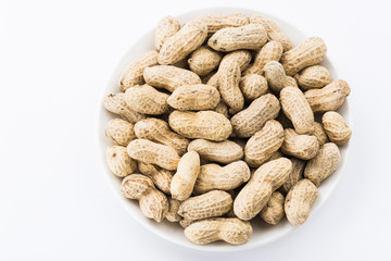 Close-up of delicious peanuts on a white dish