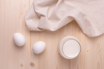Fototapeta na wymiar two white eggs and milk as calcium concept. minimalism style.