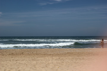 Fototapeta na wymiar A woman in the beach with the sea 