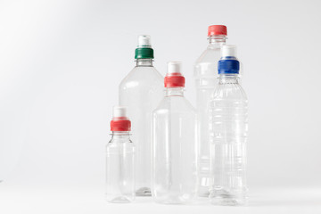 Empty plastic bottles of various sizes. White Background.