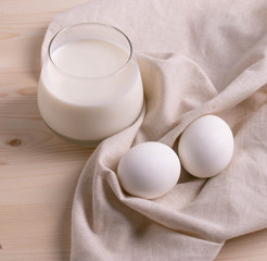two white eggs and milk as calcium concept. minimalism style.