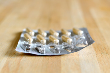 Medicine blister half used on a wooden table