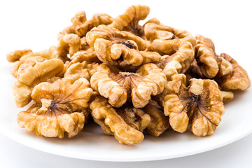Close-up of delicious walnuts on a white dish
