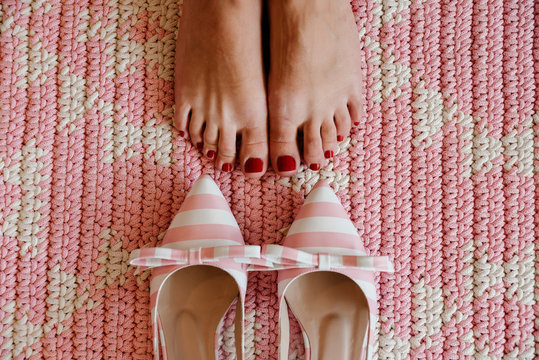 Striped footwear near feet on carpet