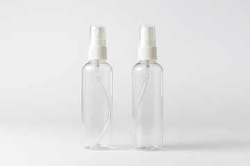 Two spray bottles for alcohol or cosmetics product on white background.