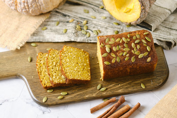 Gluten Free Pumpkin bread loaf set white cafe table.