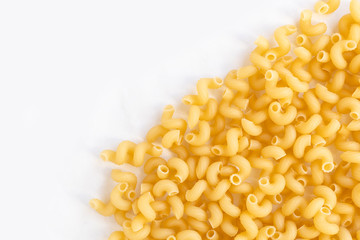bright yellow pasta spirals on white surface with copy space