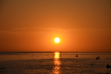 Beautiful sunset above the sea reflection of the setting sun in the water.