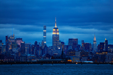 View of New York Manhattan downtown over Hudson river on moody overcast night