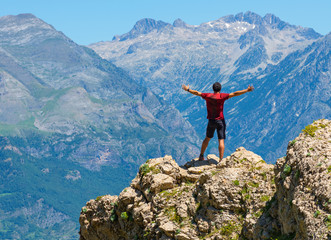 Male hiker standing on top of mountain. Active lifestyle concept.