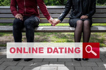 ONLINE DATING. Relationships, love, feelings and family concept. Woman and man sitting on a bench