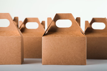 Cardboard boxes on a white background. Ecological packaging of paper products close-up and copy space. Craft containers, packaging, boxes, packages.