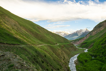 Old military road to Truso valley in Kazbegi national park. Sureal and beautiful green landscapes of caucausus.Scenic roads of Georgia