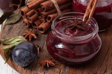 Fresh homemade plum and cinnamon jam in glass jars