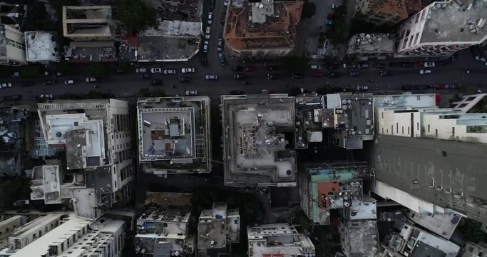 2020 Beirut port explosion: aerial aftermath directly above destruction, devastation and destroyed buildings by ammonium nitrate blast in downtown industrial warehouse, overhead drone descend