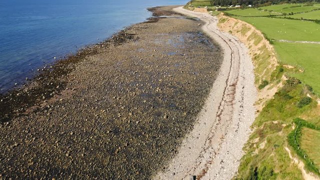 Rocky Beach Coast of Llyn Peninsula in Wales - Aerial Drone Tilt Up Reveal