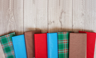 Books textbook in colorful covers on a wooden background. Back to school distance home education.Quarantine concept of stay home.