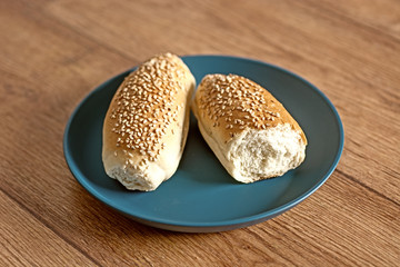 two sandwiches with sesame seeds in blue plate - closeup