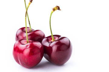 three sweet cherries on white background