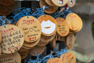 round Ema, a row of wooden prayers and wishes in a Japanese temple or shrine 