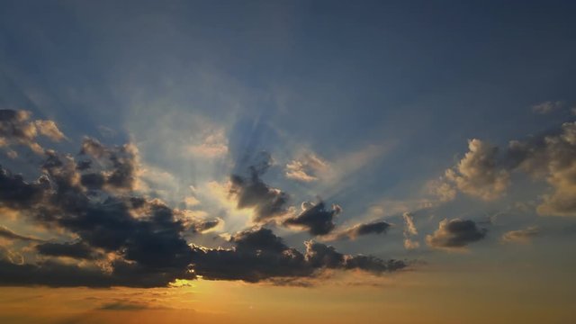 Romantic colorful sunset at the sun go down, blue and orange clouds flow in sky majestic summer landscape motion timelapse 4K footage