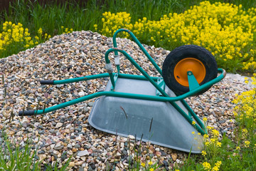 Inverted Construction Wheelbarrow lies on a pile of rubble.