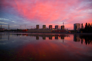 New homes are reflected in the river at dawn.