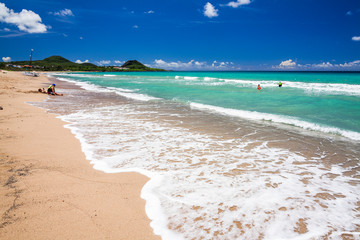 Ocean waves, beach, and blue sky in the Kenting National Park of Pingtung, Taiwan.