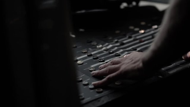 man in jacket and a white shirt with hours and rings on drawn opens box with buttons