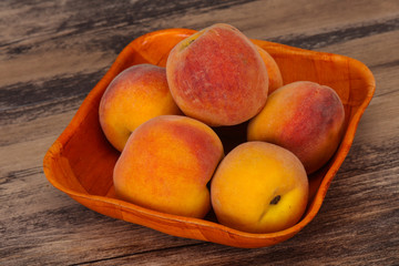 Peach heap in the wooden basket
