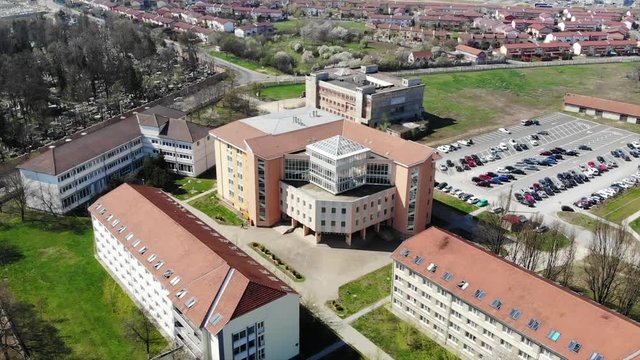 Aerial Drone Shot paning over above Universitatea Oradea Campus library with students