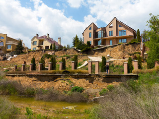 landslide caused by torrential rains of hurricane CHRISTIE. Broken road asphalt cracked, and came down with landslide. Destroyed residential buildings of cottage town elite settlement. earthquake