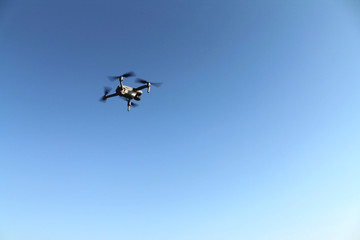 Naklejka na ściany i meble Drone flying over blue sky