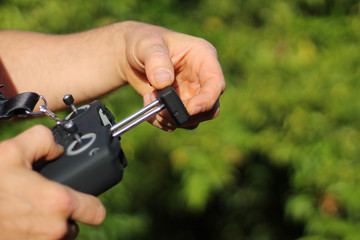 Fototapeta premium Unrecognizable drone pilot holding the RPA radio control systems to fly over crops