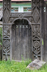 Traditional carved ancient wooden gate. Maramures, Romania.