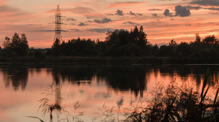 Fototapeta na wymiar Red-blue sunset reflected in lake symmetrically.