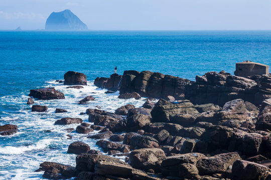 The beautiful coastal reef and sea waves with blue sky in New Taipei, Taiwan