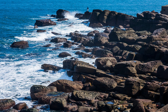 The beautiful coastal reef and sea waves with blue sky in New Taipei, Taiwan