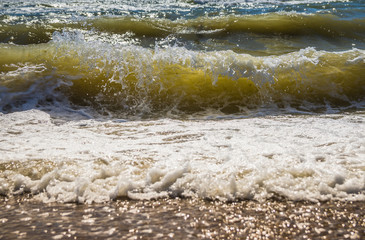 The rough sea. High waves. View from the sandy beach