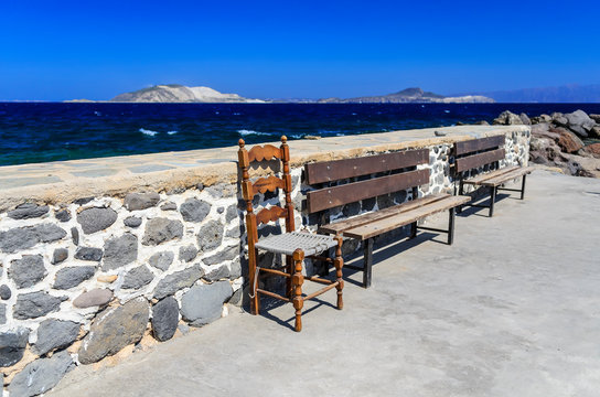 A place to rest on the pier of the town of Mandraki on the island of Nikia overlooking the islands of Giali and Stroggili. Greece