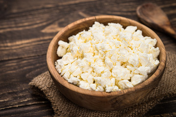 Curd or cottage cheese at wooden table.