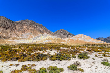 Mountains and desert landscape framing the crater of the Stefanos volcano on the island of Nisyros, Greece