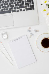 Mockup white notebook, laptop a cup of coffee on a white background