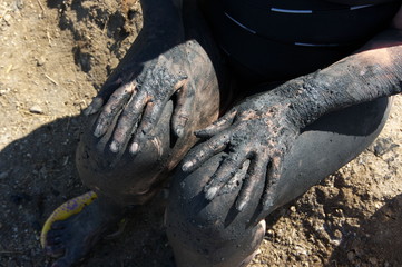 Female hands in mud therapy