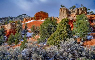 Red rocks with clouds and snow