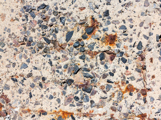 Reinforced concrete surface is covered with cracks, scratches, inclusions of granite and rusty metal bars. You can use as the background for any of your project.